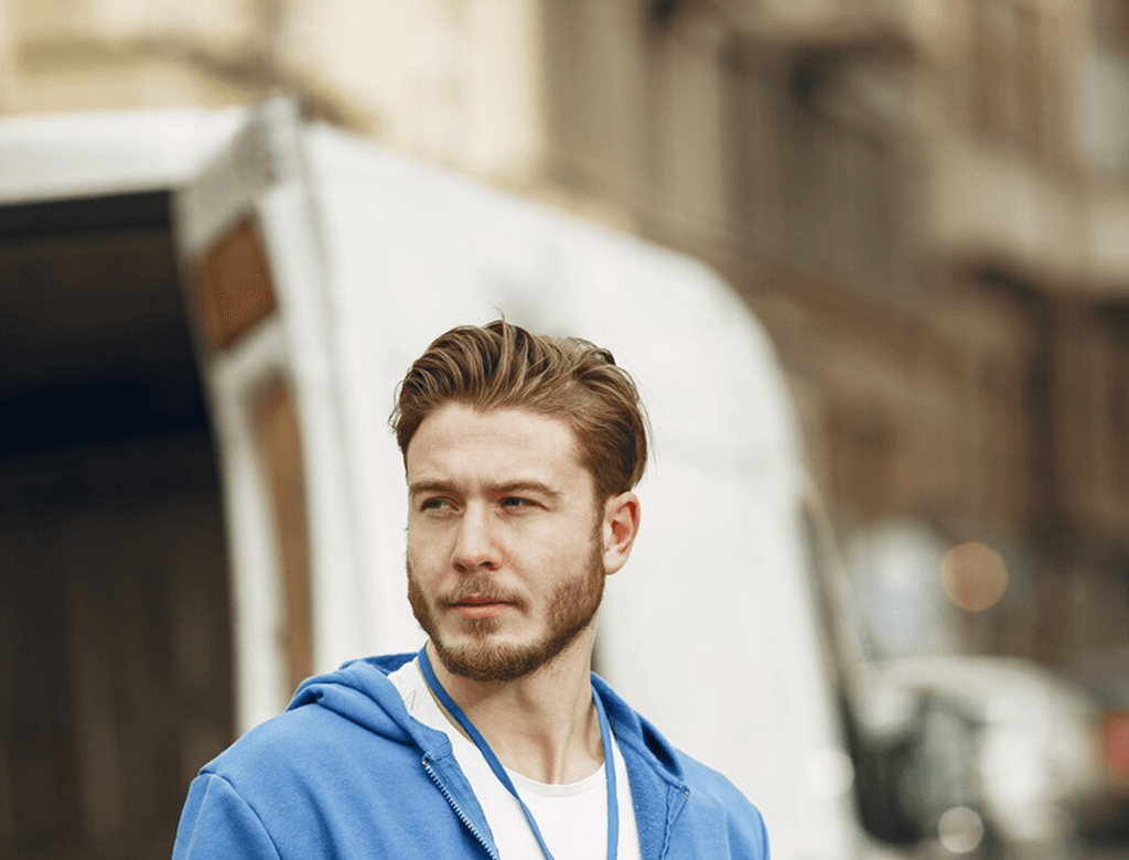 Delivery man by truck with clipboard